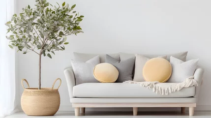 Gordijnen Wicker pot with blossom tree near beige sofa with many pillows and plaid. Scandinavian interior design of modern stylish living room © Samira