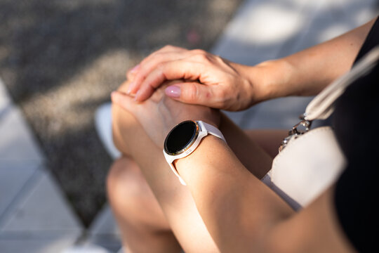 Woman Hand Wearing A Smartwatch And Checking Active Lifestyle And Using Fitness Tracker Outdoor On The Beach.