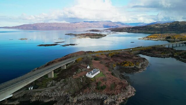 Drone descends and pulls away from coastal island between Skye bridge in Scotland