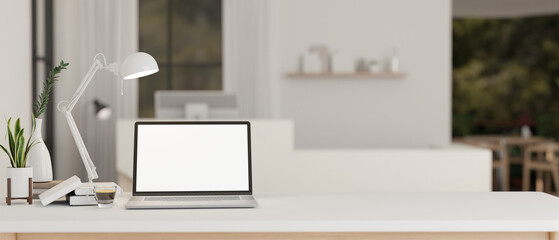 Fototapeta na wymiar Workspace with a white-screen laptop mockup on a white tabletop in a modern white lobby.