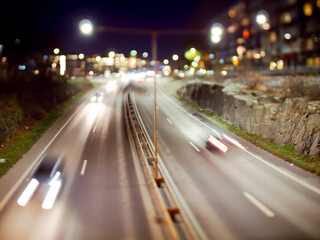 Fototapeta na wymiar Long exposure tilt shift image of traffic passing on a highway..