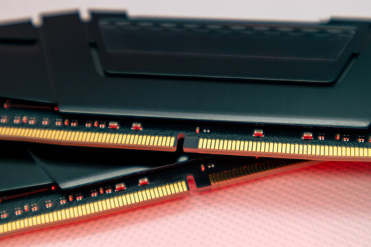 DDR4 DRAM memory modules in red light. Computer RAM chip close-up on white. Desktop PC parts for assemble