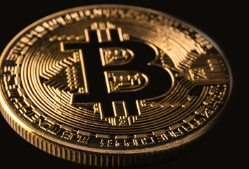 Mockup golden bitcoin close up on black background with clipping path. Bitcoin or BTC is the most...