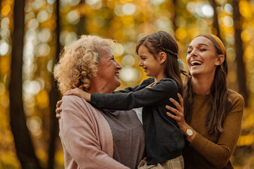 Portrait of lovely three female generations in the nature