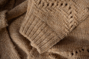 Stylized fashionable look. beige knitted sweater. Close-up knitting texture. Social media background. Soft, warm sweater