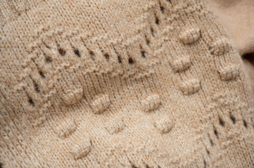 Stylized fashionable look. beige knitted sweater. Close-up knitting texture. Social media background. Soft, warm sweater