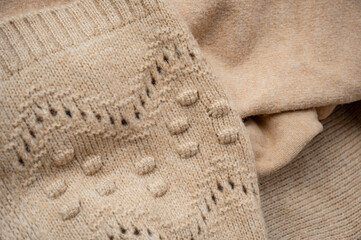 Stylized fashionable look. beige knitted sweater. Close-up knitting texture. Social media background. Soft, warm sweater