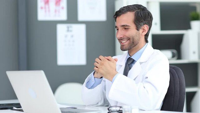 Doctor speaks with patient using laptop online
