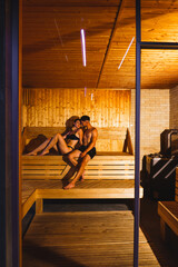 Obraz na płótnie Canvas Shot of a young couple relaxing in a sauna.Hotel holiday concept
