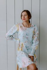 Beautiful woman posing and looking away. Stylish dress.