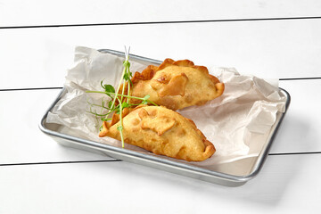 Savory puff pastry turnovers filled with salmon, spinach, cream cheese and herbs