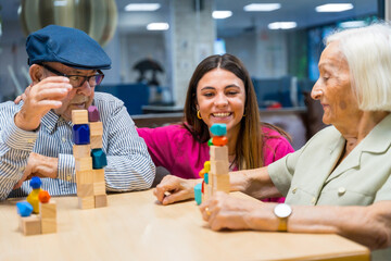 Nurse supervising seniors playing skill games in a nursing home