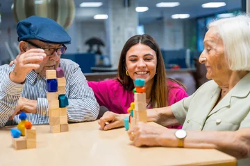 Foto op Plexiglas Nurse supervising seniors playing skill games in a nursing home © unai