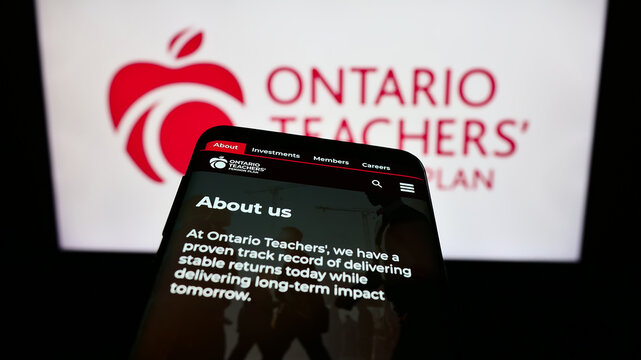 Stuttgart, Germany - 10-13-2023: Mobile phone with webpage of organization Ontario Teachers' Pension Plan Board (OTPP) in front of logo. Focus on top-left of phone display.
