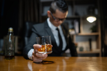 Businessman wearing a suit whiskey glass of liquor.