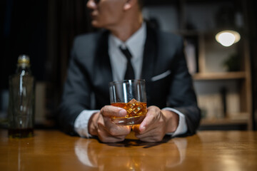 Businessman wearing a suit whiskey glass of liquor.