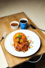 Chicken Majboos biryani rice pulao served in plate with sauce, cold drink, spoon and fork isolated on wooden board side view of arabic food