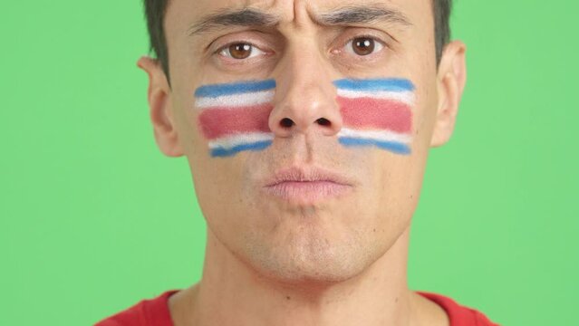 Serious man with a costa rican flag painted on the face