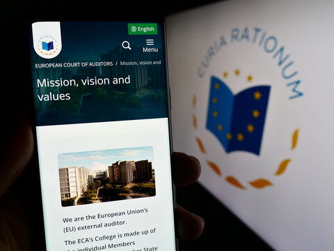 Stuttgart, Germany - 10-16-2023: Person holding cellphone with web page of EU institution European Court of Auditors (ECA) in front of logo. Focus on center of phone display.
