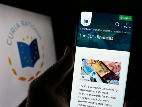 Stuttgart, Germany - 10-16-2023: Person holding smartphone with webpage of EU institution European Court of Auditors (ECA) in front of logo. Focus on center of phone display.