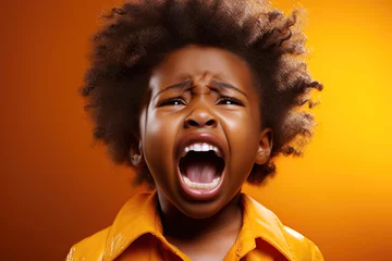 Fotobehang black child boy screaming on yellow isolated background © alexkoral