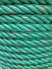 Texture of a coil of polypropylene green rope , Green Rope Background