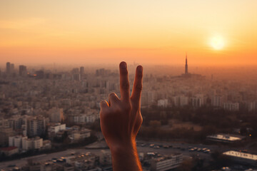 Generative AI Image of Two Fingers Symbolizing Peace on Cityscape Background at Sunset