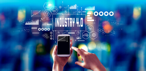 Industry 4.0 theme with person using a smartphone in a city at night