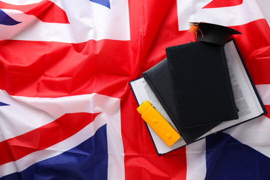 A book with a graduation cap and the flag of Great Britain