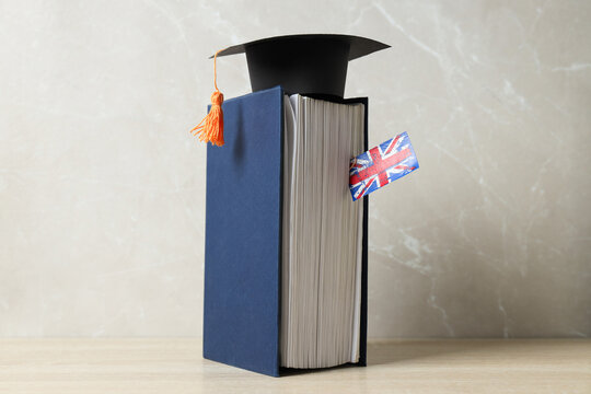 A book with a graduation cap and the flag of Great Britain