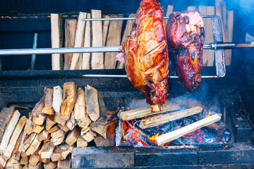 Roast pork on a spit. Roast meat on the spit over the fire in the open air