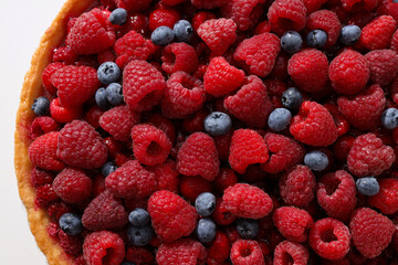 Berry pie with raspberries and blueberries on white background, close up