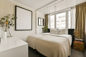 a bedroom with a bed and flowers on the bedside table in front of the bed is framed by a black frame