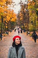 beautiful woman in autumn outfit at city public park