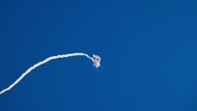 Missile attack, explosion in the air. An anti-aircraft missile has hit its target in the blue sky. Air defence. Shot down, war in the sky. Smoke in the sky after air missile SAM. Slow motion video