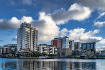 Fototapeta premium Modern architecture, tall building with restaurants, offices and apartments in Grand Canal. Modern cityscape, Dublin docklands, Ireland