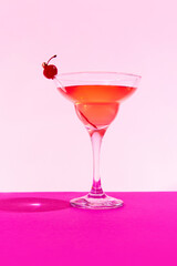 Poster. Vibrant margarita cocktail, tantalizingly decorated with red cherry standing on podium against vivid colorful background.