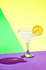 Poster. Zesty margarita adorned with salt and lemon slice showcased against dynamic vibrant studio background.
