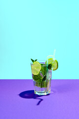 Fresh, cool cocktail, mojito isolated over blue and purple background. Sumer taste. Refreshing. Concept of alcohol and non-alcoholic drinks, party, holidays, bar, mix. Poster. Copy space for ad