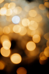 Fototapeta premium Abstract background of blurred yellow lights for design. Lights bokeh dis focus. Christmas background, copy space