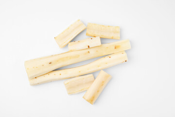 Cut raw salsify roots on white background, flat lay