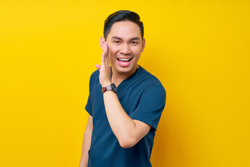 Professional young Asian male doctor or nurse wearing a blue uniform whispering gossip in the...