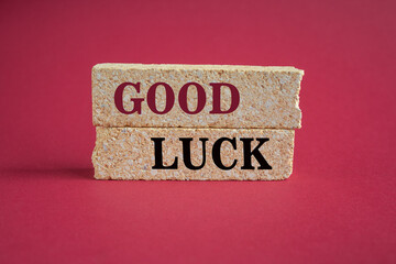 Good luck symbol. Concept words Good luck on beautiful brick blocks. Beautiful red background. Business, motivational good luck concept. Copy space.