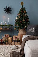 Cozy and stylish christmas living room interior with, modular sofa, wooden console with spruce,...