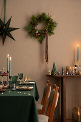 Interior design of Christmas dinning room interior with table, christmas wearth, candle, brown...