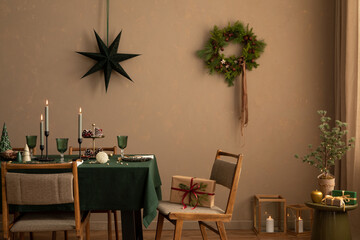 Creative composition of christmas living room interior with table, chair, candle with candlestick,...