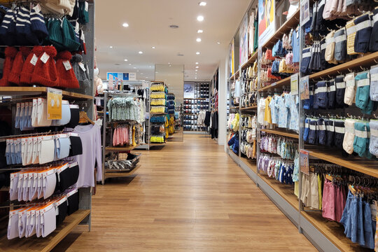 PENANG, MALAYSIA - 24 OCT 2022: Modern interior view of Uniqlo store in a shopping mall, Penang. Uniqlo Co., Ltd. is a Japanese casual wear designer, manufacturer and retailer.