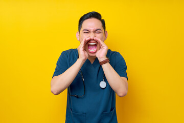 Professional young Asian male doctor or nurse wearing a blue uniform feeling angry and loudly...