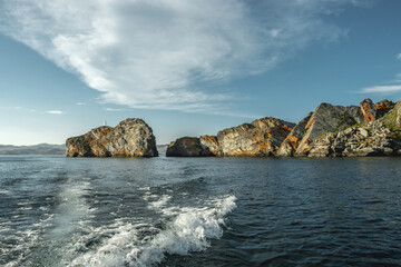 Rock on the island of Olkhon Lake Baikal. Summer landscape with reflection in the water on a clear sunny day. Unique places of Siberia