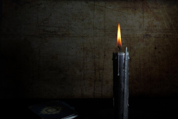 Black candle and tarot cards on dark background with space for text. Tarot cards and esoteric concept